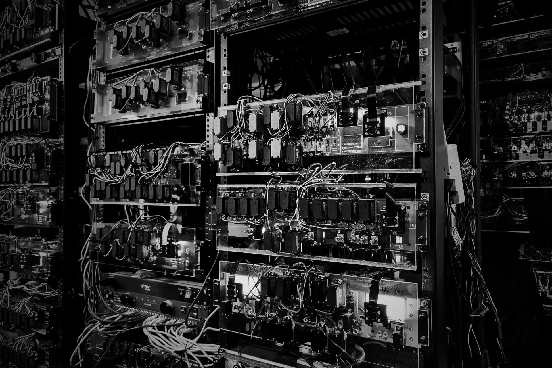 Floor-to-ceiling studio racks of real analog hardware in the Access Analog facility