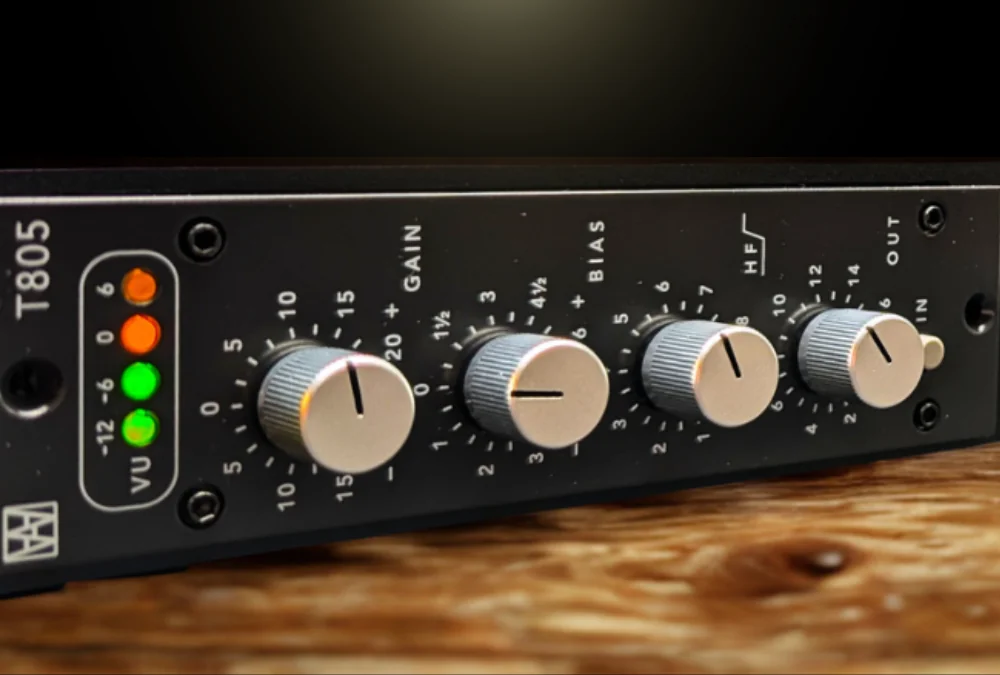 Close-up of the Walters Audio T805 hardware showing its VU LED meter and the Gain, Bias, HF, and Out knobs under warm studio lighting.