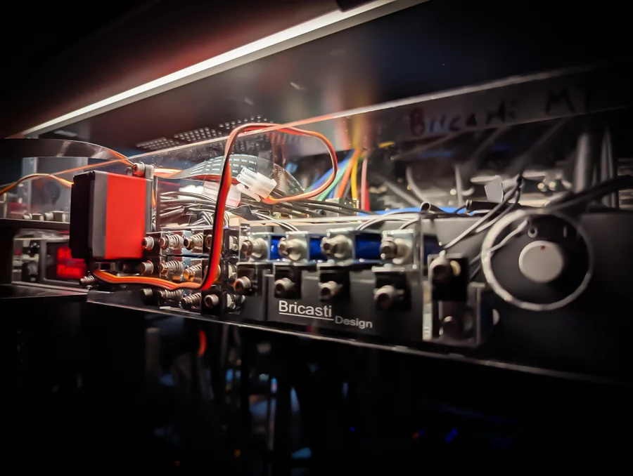 Access Analog's robotic actuators mounted on a real Bricasti M7, physically turning its knobs and switches for remote control and full recall.